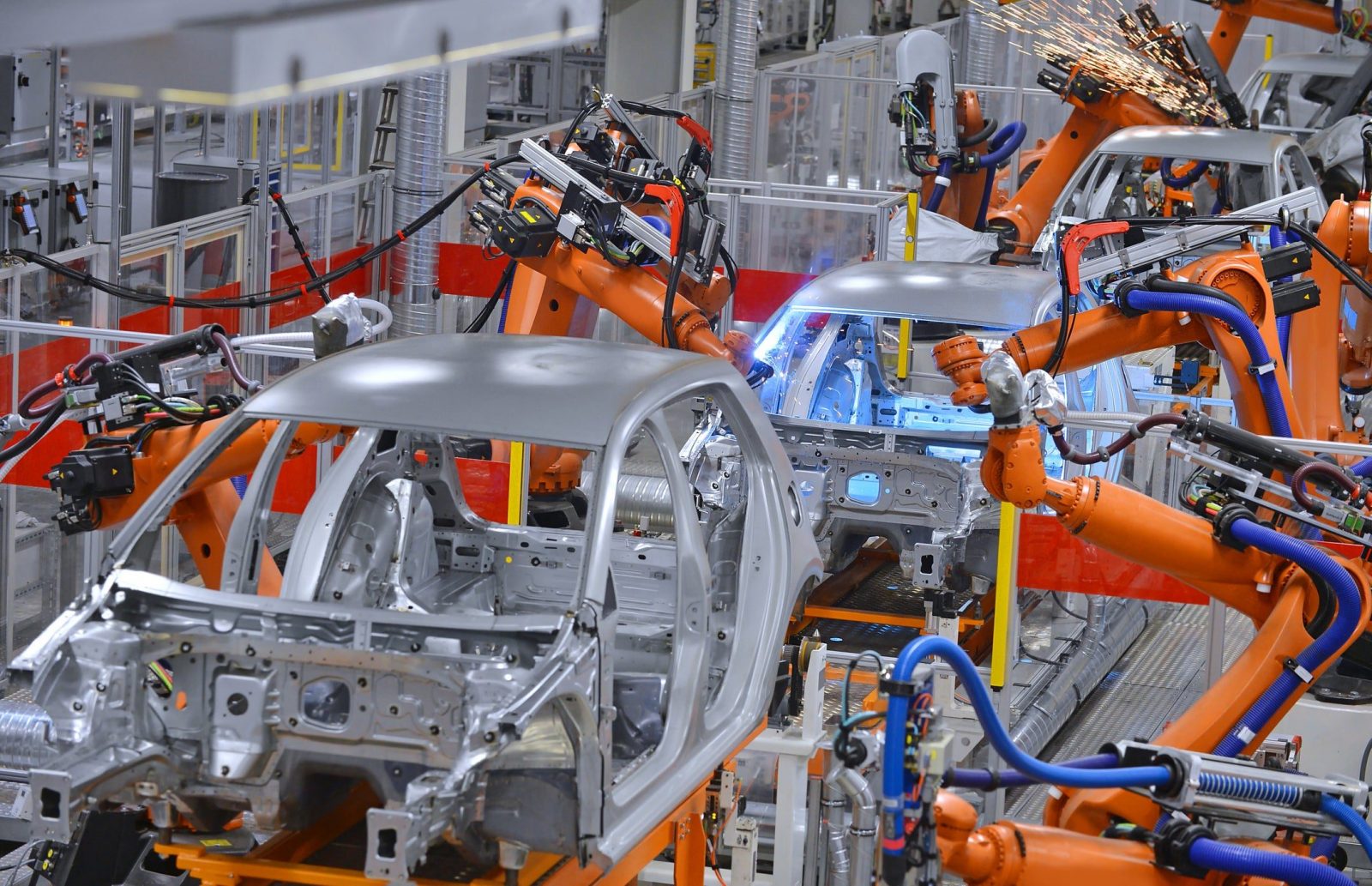 Background image: Autoliv robots welding in an automobile factory